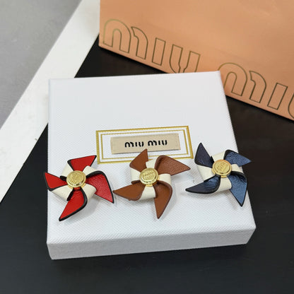 Leather pinwheel brooch