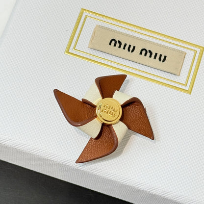 Leather pinwheel brooch