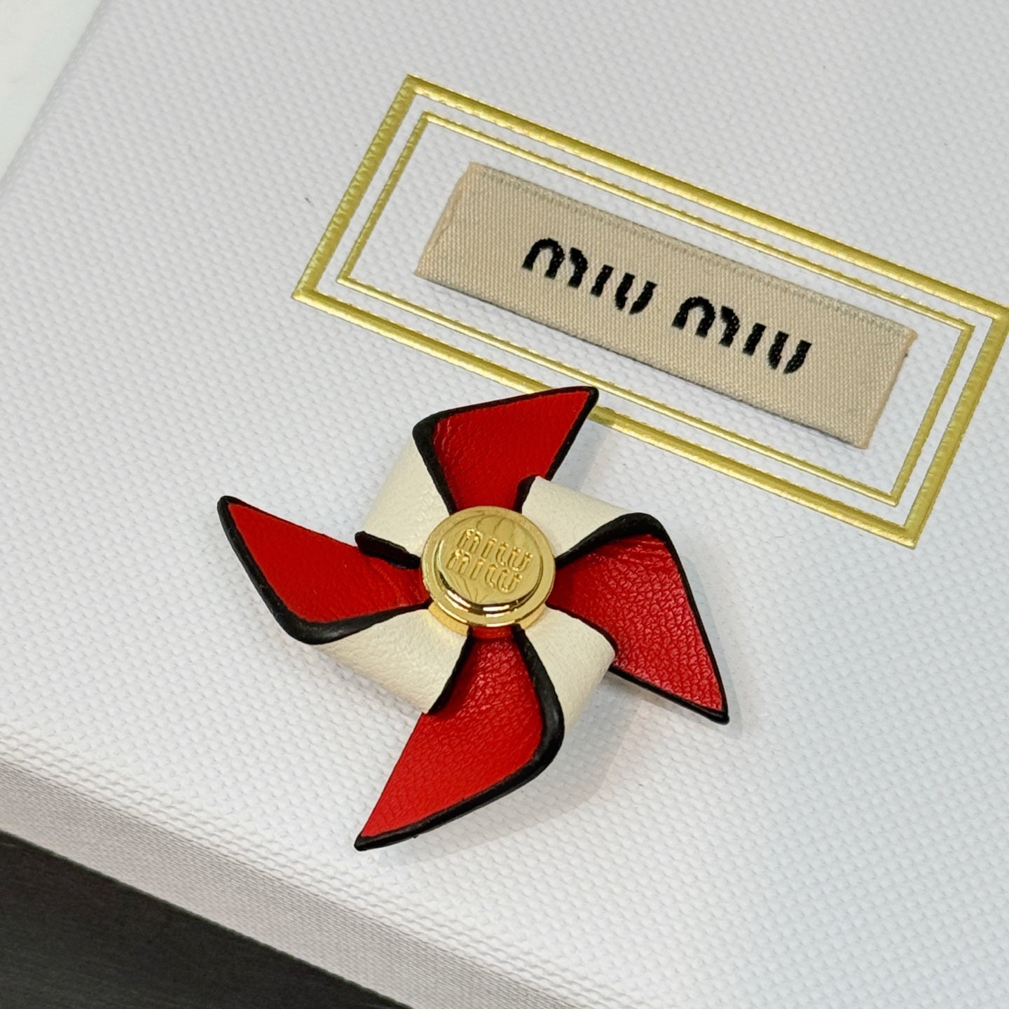 Leather pinwheel brooch
