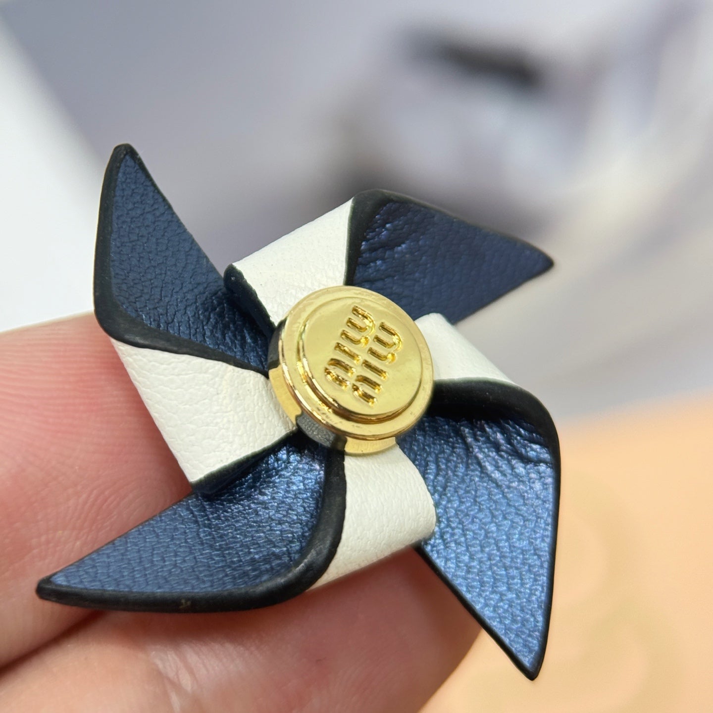 Leather pinwheel brooch